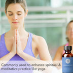 A woman in a purple tank top is sitting with her hands in a prayer position, eyes closed, in a meditative state. Beside her is a bottle of Frankincense Essential Oil, 1 fl oz with text stating its use for enhancing spiritual and meditative practices like yoga.