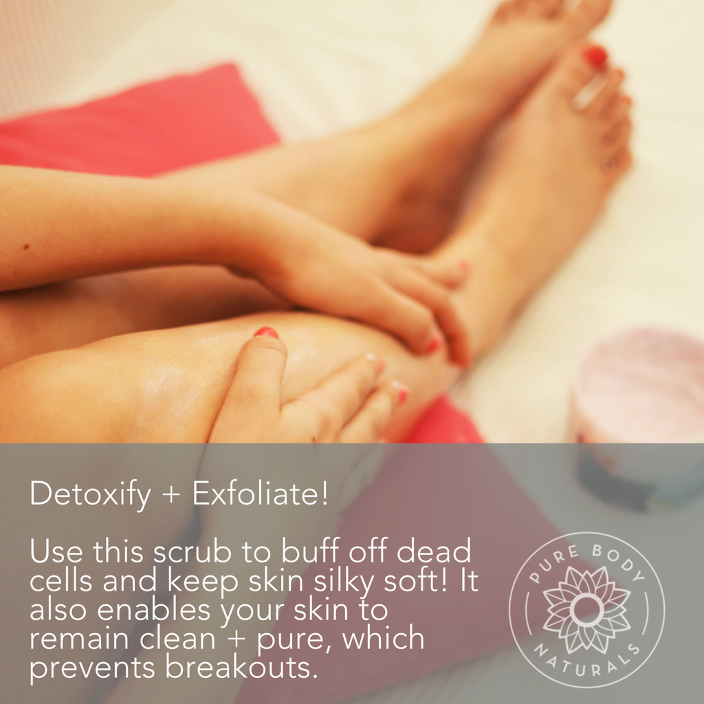 A person applying a body scrub to their legs, with their feet and a container of the scrub visible in the background. The text reads: "Detoxify + Exfoliate! Use this *Himalayan Pink Salt Exfoliating Scrub* to buff off dead cells and keep skin silky soft! It also enables your skin to remain clean + pure, which prevents breakouts." The Pure Body Naturals logo is in the bottom right corner.