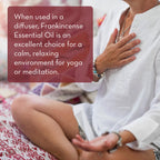 A person sits cross-legged on a patterned surface, wearing a white top and holding their chest with one hand while resting the other on their knee. A text box reads, "When used in a diffuser, Frankincense Essential Oil, 4 fl oz is an excellent choice for a calm, relaxing environment for yoga or meditation.