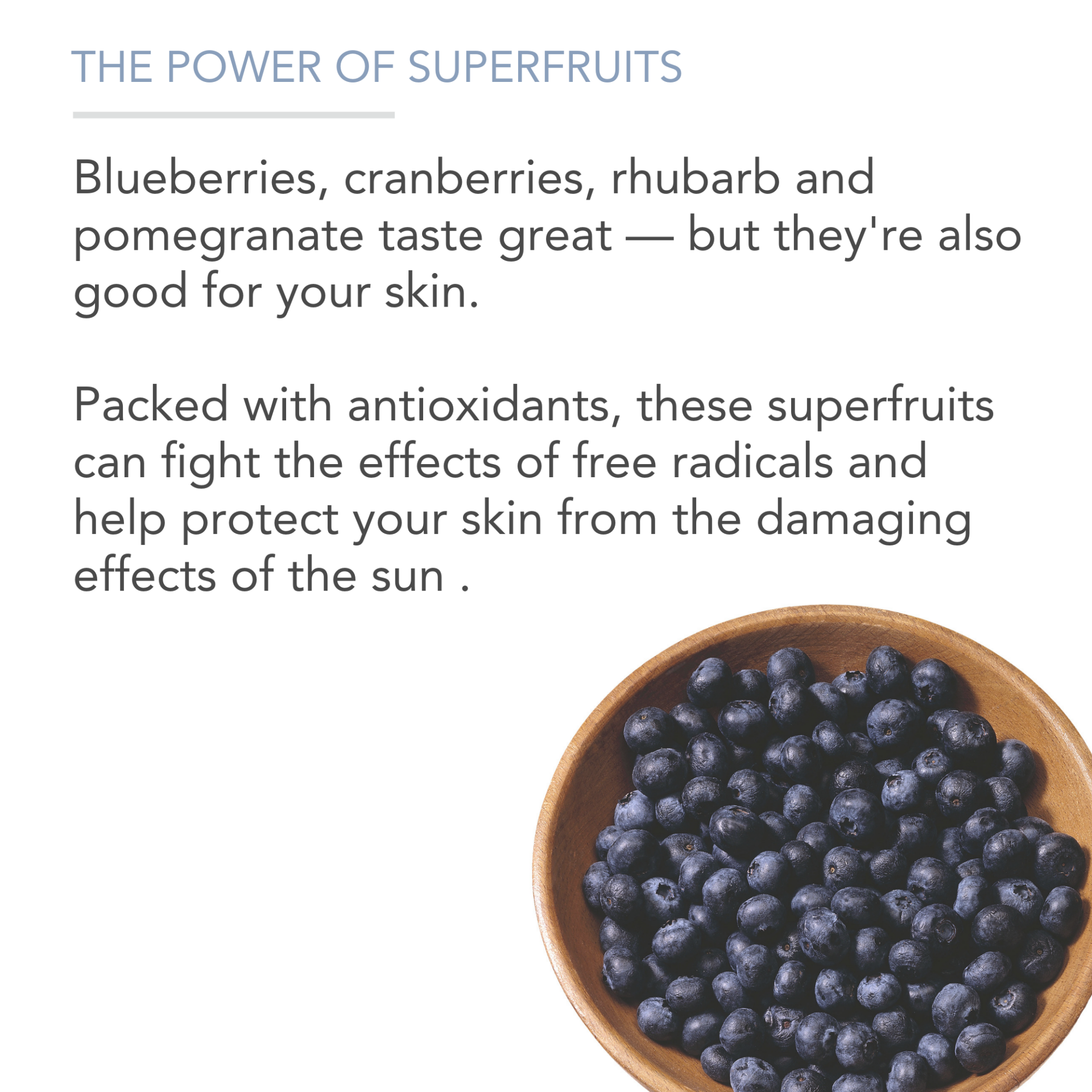 A bowl of blueberries sits to the bottom right. Text above reads: "THE POWER OF SUPERFRUITS. Blueberries, cranberries, rhubarb, and pomegranate taste great — but they're also good for your skin. Packed with antioxidants, these superfruits help protect your skin from free radicals and the damaging effects of the sun.
Superfruit Smoothie Scrub