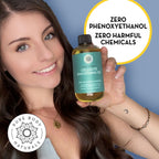 Woman holding a bottle of cellulite smoothing oil with text about zero harmful chemicals on a blue background.