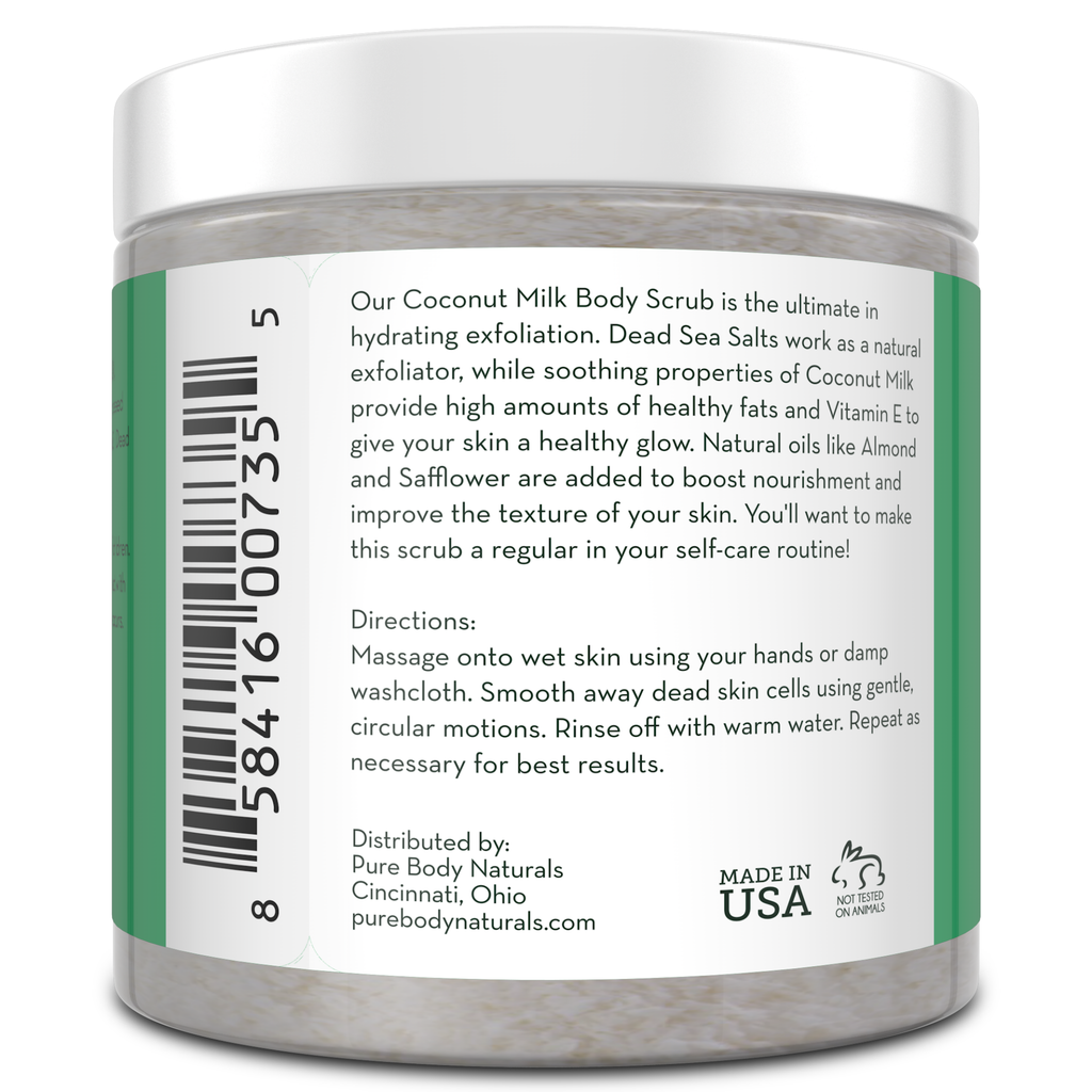 A white plastic jar with a green label displaying a barcode, product description, directions for use, manufacturer's information, and "Made in USA" label. The product is a Coconut Milk Exfoliating Body Scrub from Pure Body Naturals, containing natural ingredients for skin exfoliation.