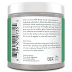 A white plastic jar with a green label displaying a barcode, product description, directions for use, manufacturer's information, and "Made in USA" label. The product is a Coconut Milk Exfoliating Body Scrub from Pure Body Naturals, containing natural ingredients for skin exfoliation.