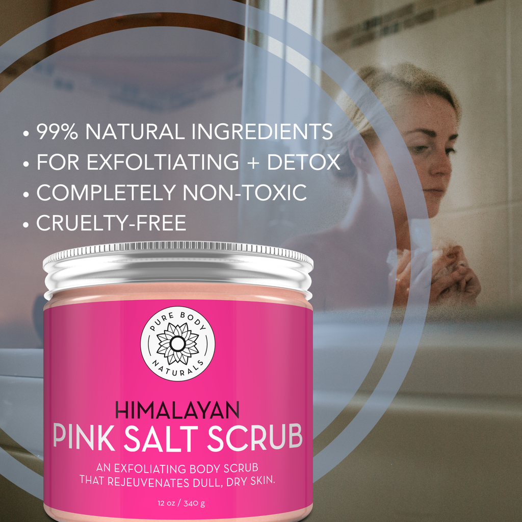 A jar of Himalayan Pink Salt Exfoliating Scrub is displayed with descriptive text highlighting its qualities: 99% natural ingredients, exfoliation and detox benefits, completely non-toxic, and cruelty-free. A woman is visible in the background in a bathroom setting.
