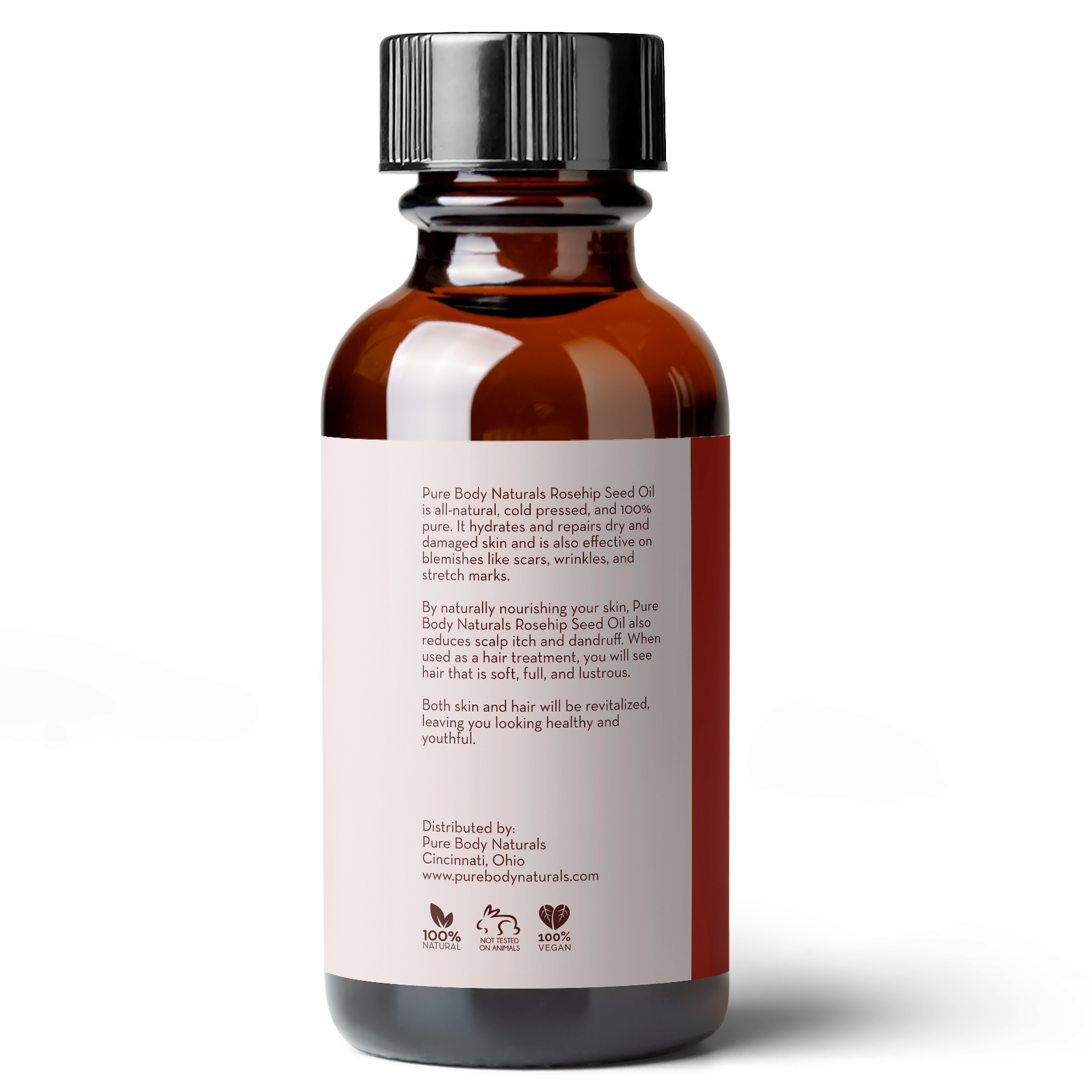 A brown glass bottle labeled "Rosehip Seed Oil, 1 fl oz" with detailed product information on the back. The bottle has a black cap and is placed against a white background. The text on the bottle mentions benefits for skin and hair, including moisturizing and reducing scars.