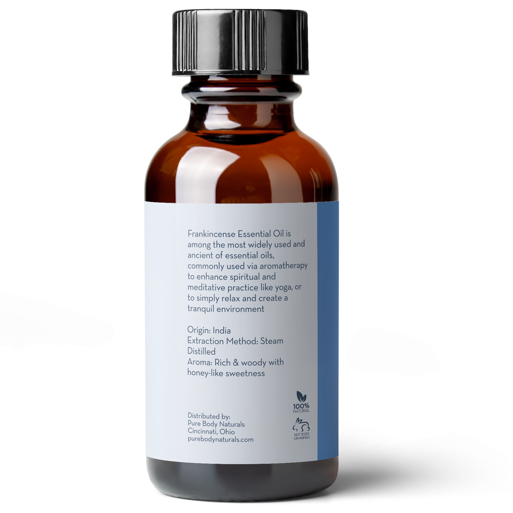 A brown glass bottle with a black cap labeled "Frankincense Essential Oil, 1 fl oz." The label describes it as enhancing spiritual and meditative practices, originating from India, with a steam-distilled extraction method. It has a rich, woody aroma with honey-like sweetness.