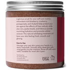 A jar of Superfruit Smoothie Scrub with a label that includes text on its benefits and usage instructions. The product features antioxidants from blueberry, cranberry, pomegranate, and rhubarb, and contains aloe vera, jojoba beads, and hibiscus. It is suitable for most skin types.
