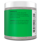 A jar of Coconut Milk Exfoliating Body Scrub with a green label lists ingredients including coconut milk, sea salt, almond oil, safflower oil, sunflower oil, grapeseed oil, apricot kernel oil, avocado oil, Dead Sea salt, and vitamin E. A warning advises keeping out of reach of children and to discontinue use if irritation occurs.