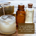 A selection of skincare items including a jar of cream, a brown glass bottle with a dropper, and a clear glass bottle with a cork stopper, arranged next to two bars of soap. Text overlay reads: "A superior substitute for Nangai Oil, 4 fl oz in DIY beauty and skincare recipes.