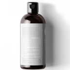 Bottle of Restore & Strengthen Shampoo for Hair Growth with a dark brown cap and a white label, containing text about ingredients and benefits. The back label features detailed information on the formulation, usage, and natural benefits of the shampoo. The background is plain white.