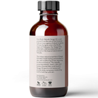 A brown glass bottle with a white label containing Nangai Oil, 4 fl oz. Text on the label describes the oil as cold-pressed, sustainably sourced, and beneficial for skin and hair. The label also highlights the product being non-GMO, cruelty-free, and vegan.