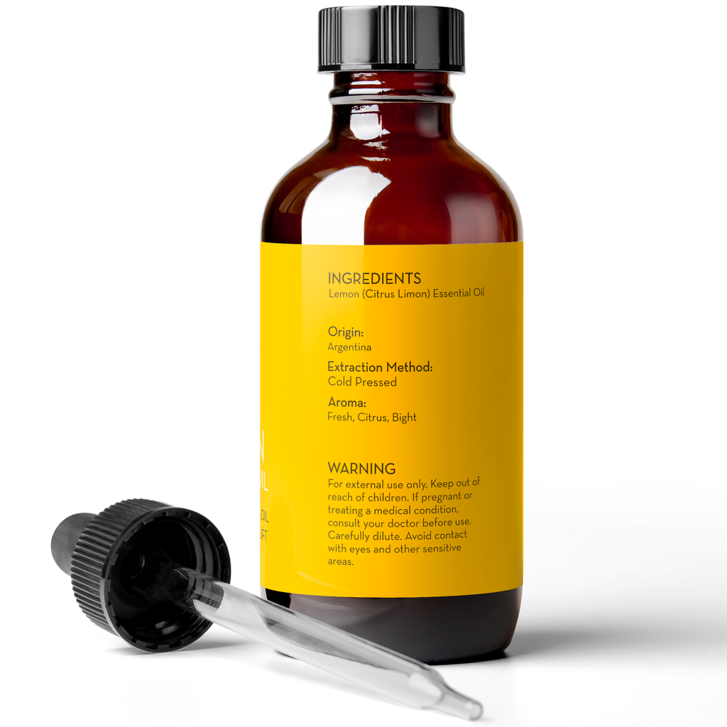 A brown glass bottle with a dropper cap placed beside it. The yellow label on the bottle provides details about the Lemon Essential Oil, 4 fl oz inside, including ingredients, origin (Argentina), extraction method (cold pressed), aroma (fresh, citrus, bright), and a warning for external use only.