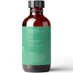 A brown glass bottle with a black cap and a green label. The label includes text listing ingredients, origin (India), extraction method (steam distilled), aroma (minty with warm undertones), and warnings about external use and keeping out of reach of children. Product Name: Peppermint Essential Oil, 4 fl oz