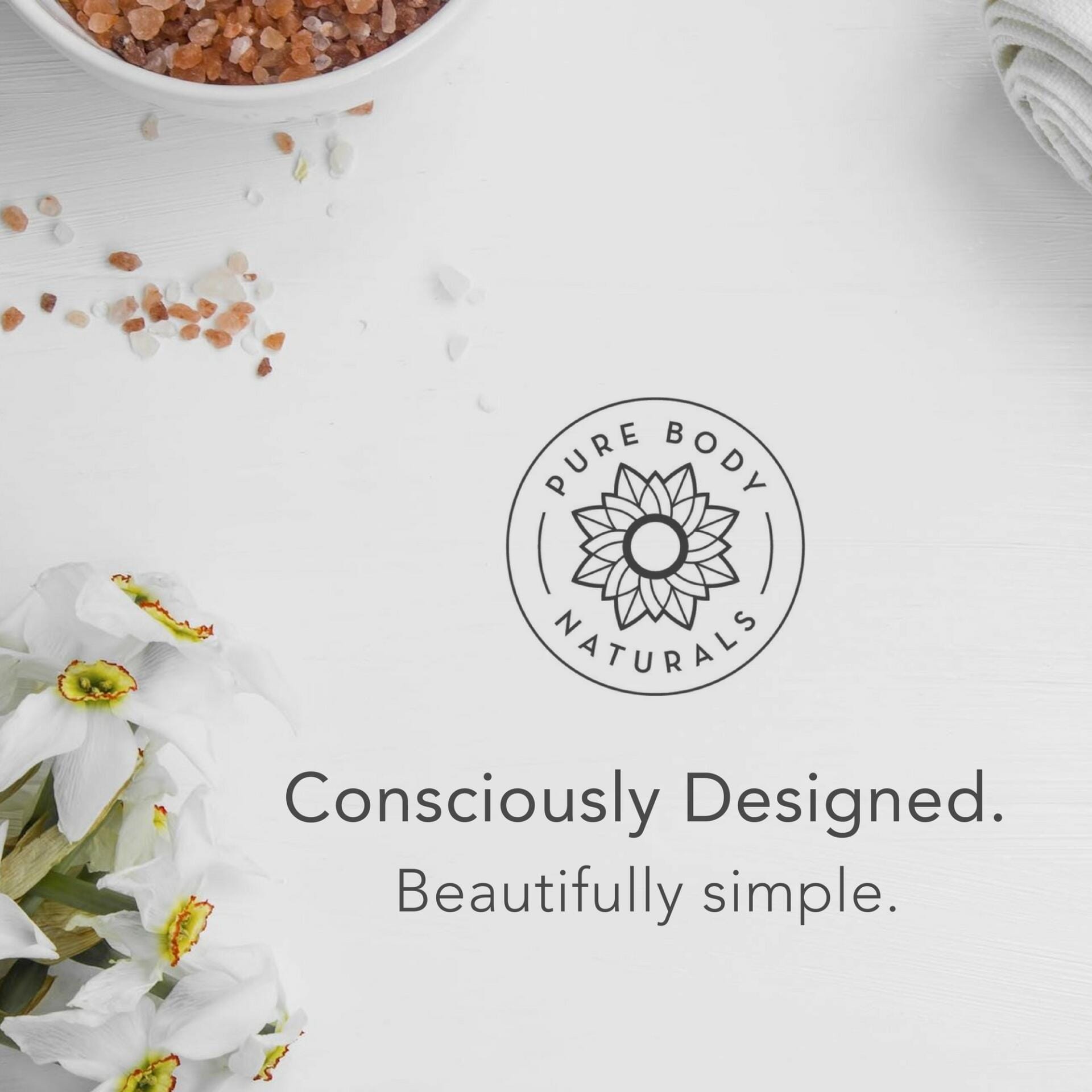 A ceramic bowl with pink Himalayan salt, a white towel, and white flowers are arranged around a logo that reads "Hair Gel for Men" with a flower design. Below the logo, text reads, "Consciously Designed. Beautifully simple.