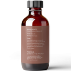 A brown glass bottle with a black cap is shown against a white background. The bottle features a label that provides information about the ingredients, origin (Vanuatu), aroma (mild, nutty), usage instructions, and a warning for external use and safety. Product Name: Nangai Oil, 4 fl oz.

