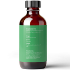 A brown glass bottle with a green label displaying Fractionated Coconut Oil, 100% Pure. The label lists the ingredients as organic fractionated coconut oil. It mentions the origin as Singapore and India, notes an odorless aroma, and provides usage and warning instructions.