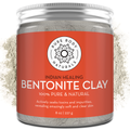 A jar labeled "Bentonite Indian Healing Clay, 100% Pure" with an orange background. The text highlights that it is 100% pure and natural, actively seeks toxins and impurities, and reveals soft, clear skin. The jar contains 8 oz (227 g) of the product.