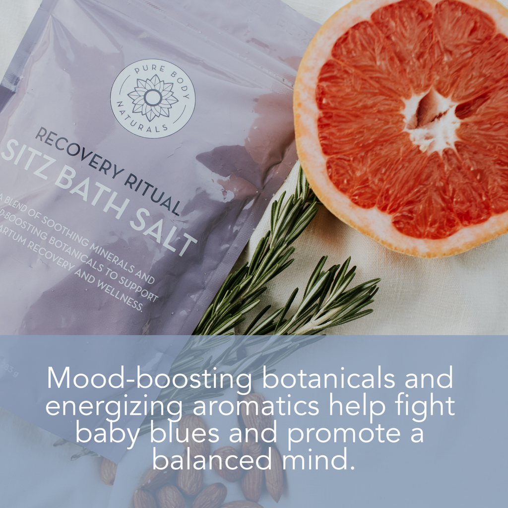 A package of "Recovery Ritual Sitz Bath Salt, 10 oz" is placed next to a sprig of rosemary and half a grapefruit. The packaging mentions its benefits, including mood-boosting botanicals and energizing aromatics to help balance the mind.