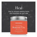 Orange jar of Indian Healing Bentonite Clay with silver lid on a dark background